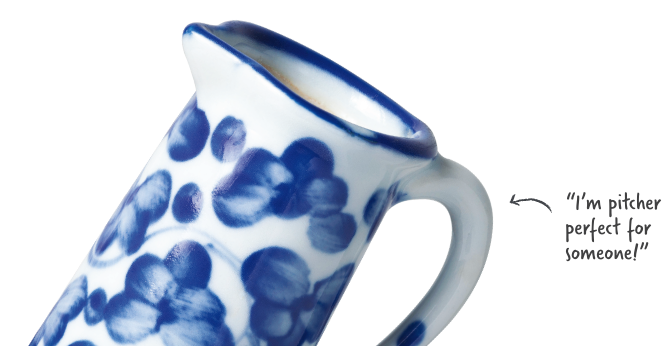 White ceramic pitcher with painted blue flowers around the sides that is appearing to say 'I'm pitcher perfect for someone!'