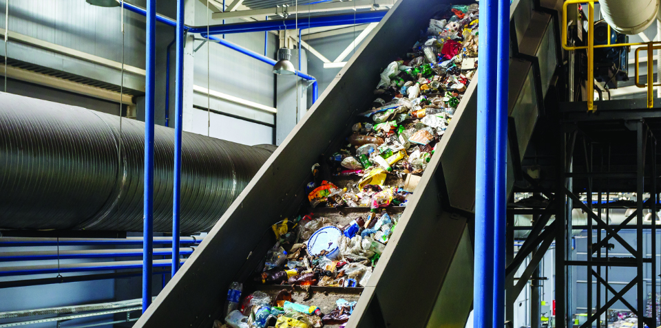 Recyclables move on a conveyor belt. Knotted piece of rope with a frayed end